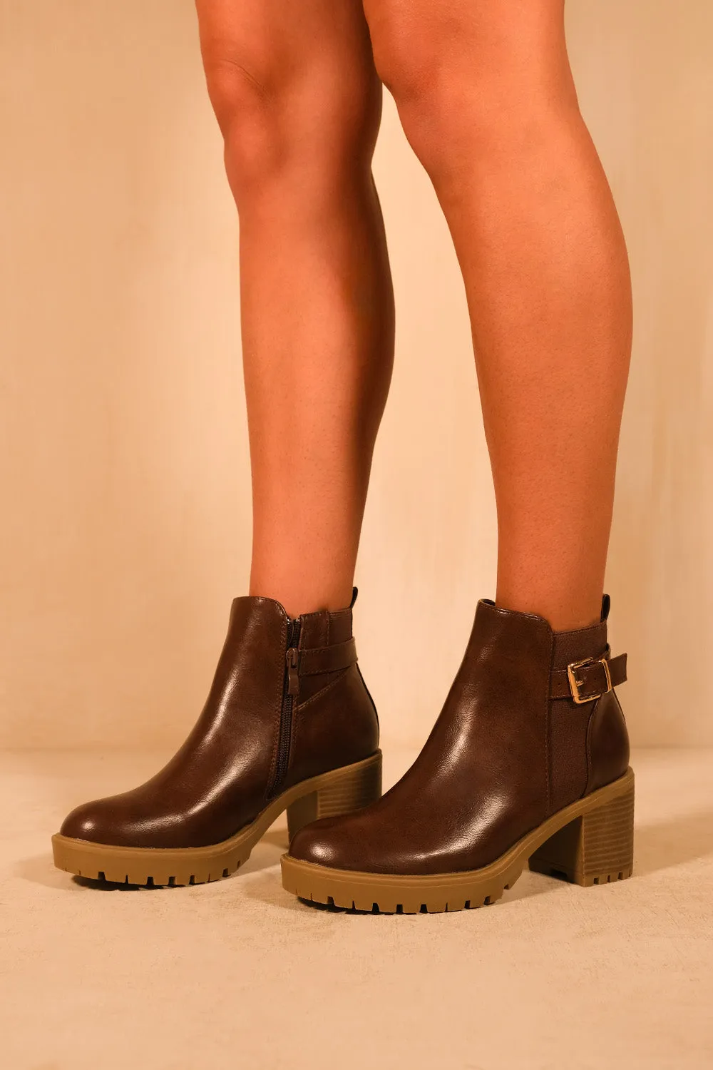 KALI MID BLOCK HEEL WITH BUCKLE DETAIL STRETCH ANKLE BOOTS IN BROWN FAUX LEATHER