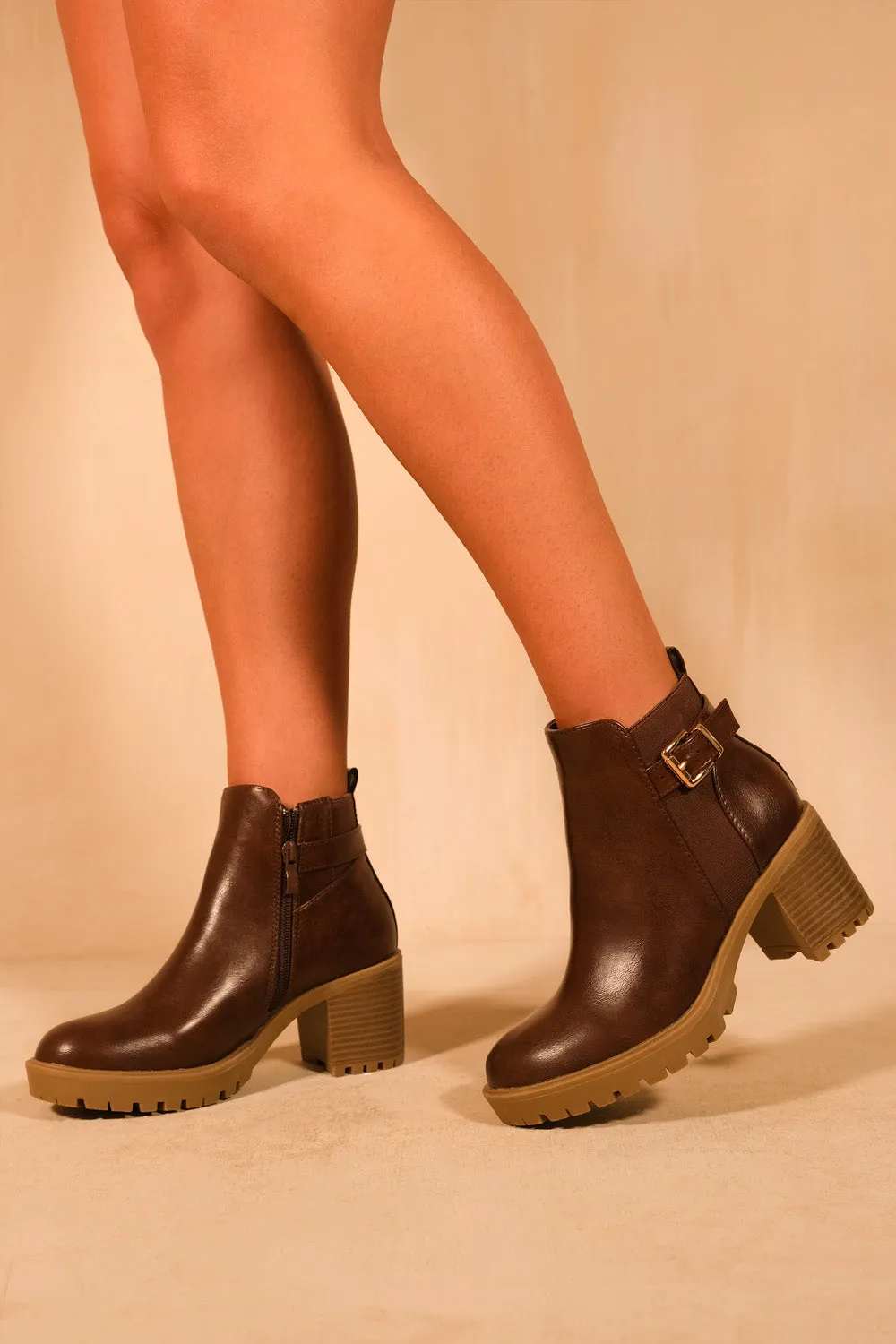 KALI MID BLOCK HEEL WITH BUCKLE DETAIL STRETCH ANKLE BOOTS IN BROWN FAUX LEATHER